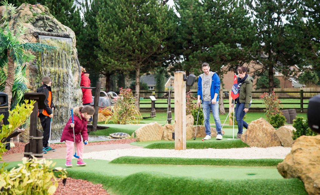 Family at Out of Bounds Adventure Golf Course in Sussex