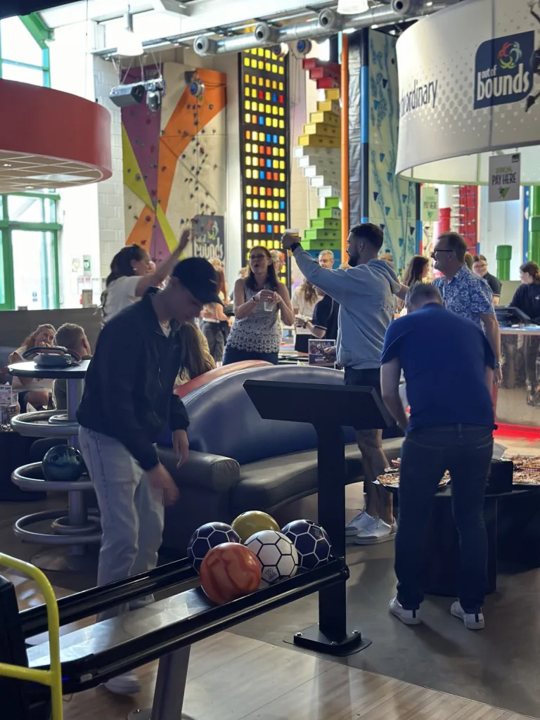 A corporate group bowling